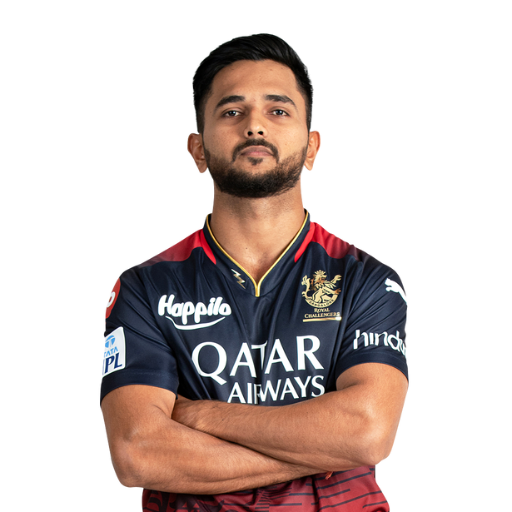 Manoj Bhandage posing in Royal Challengers Bengaluru jersey 2025