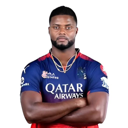 Romario Shepherd posing in Royal Challengers Bengaluru jersey 2025