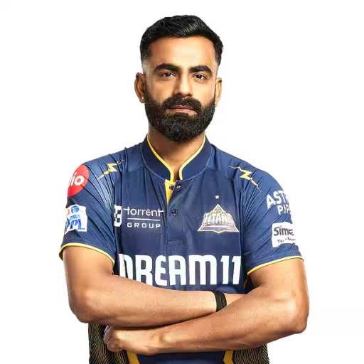 Kulwant Khejroliya posing in gujarat titans jersey